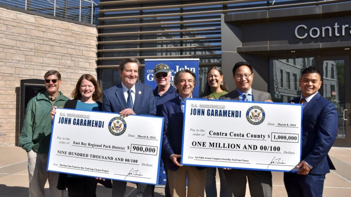 Representative Garamendi presenting checks for community projects.