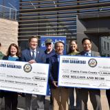 Representative Garamendi presenting checks for community projects. 