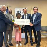 Congressman John Garamendi presenting the check with Richmond Mayor Eduardo Martinez, Community Housing Development Corporation Executive Director Donald Gilmore, the longest-tenured Pullman Point resident Ms. Linda Daniels, and HUD's Honorable Adrianne Todman. 