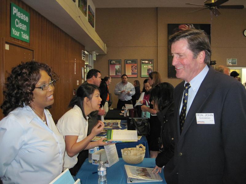 Congressman Garamendi talks to representatives of a health care
company at their booth at the Congressman’s job resources fair