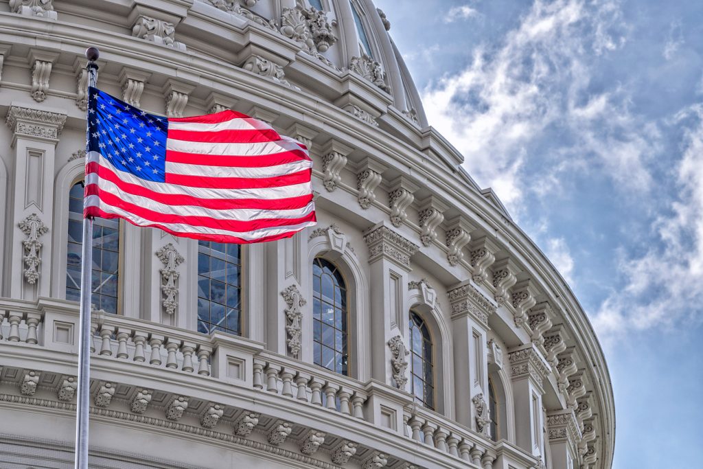 Washington DC Capitol dome detail with waving american flag